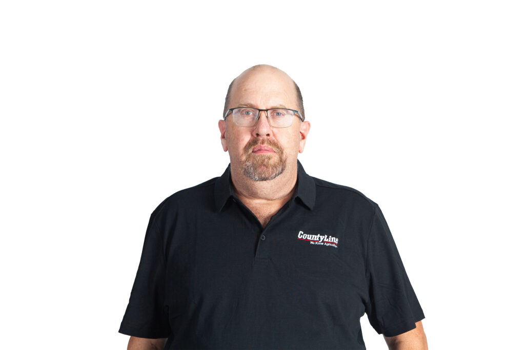 Male, Caucasian, Black polo shirt with CLE logo, Balding with glasses, Beard and moustache