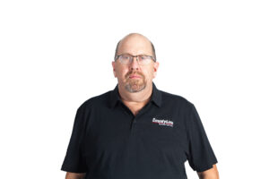 Male, Caucasian, Black polo shirt with CLE logo, Balding with glasses, Beard and moustache