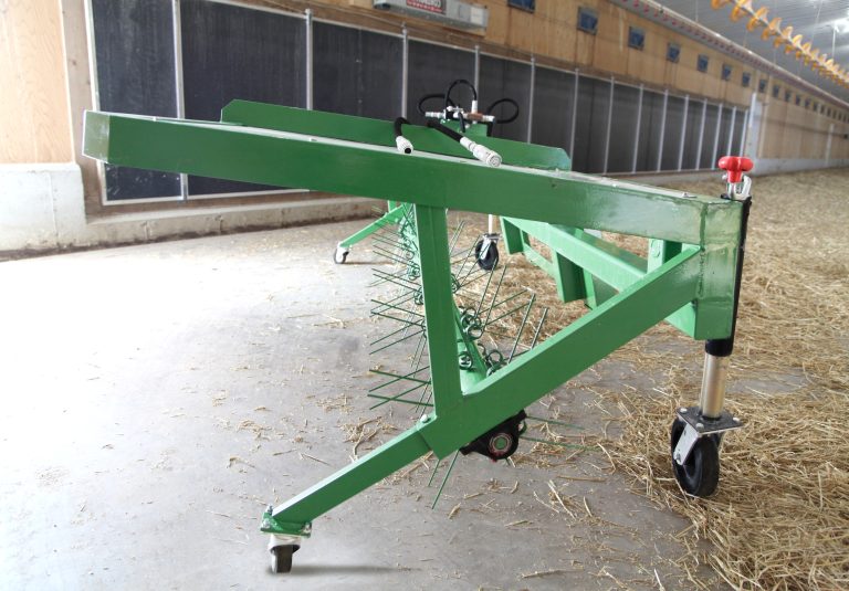 Green rotary fork agricultural equipment with rotating tines and adjustable support frame at County Line Equipment.