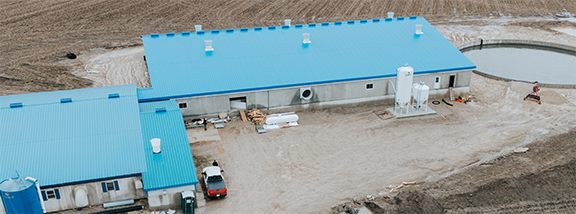 Aerial view of the New Venture Farms gestation hog barn featuring a modern swine facility designed for efficient livestock production.